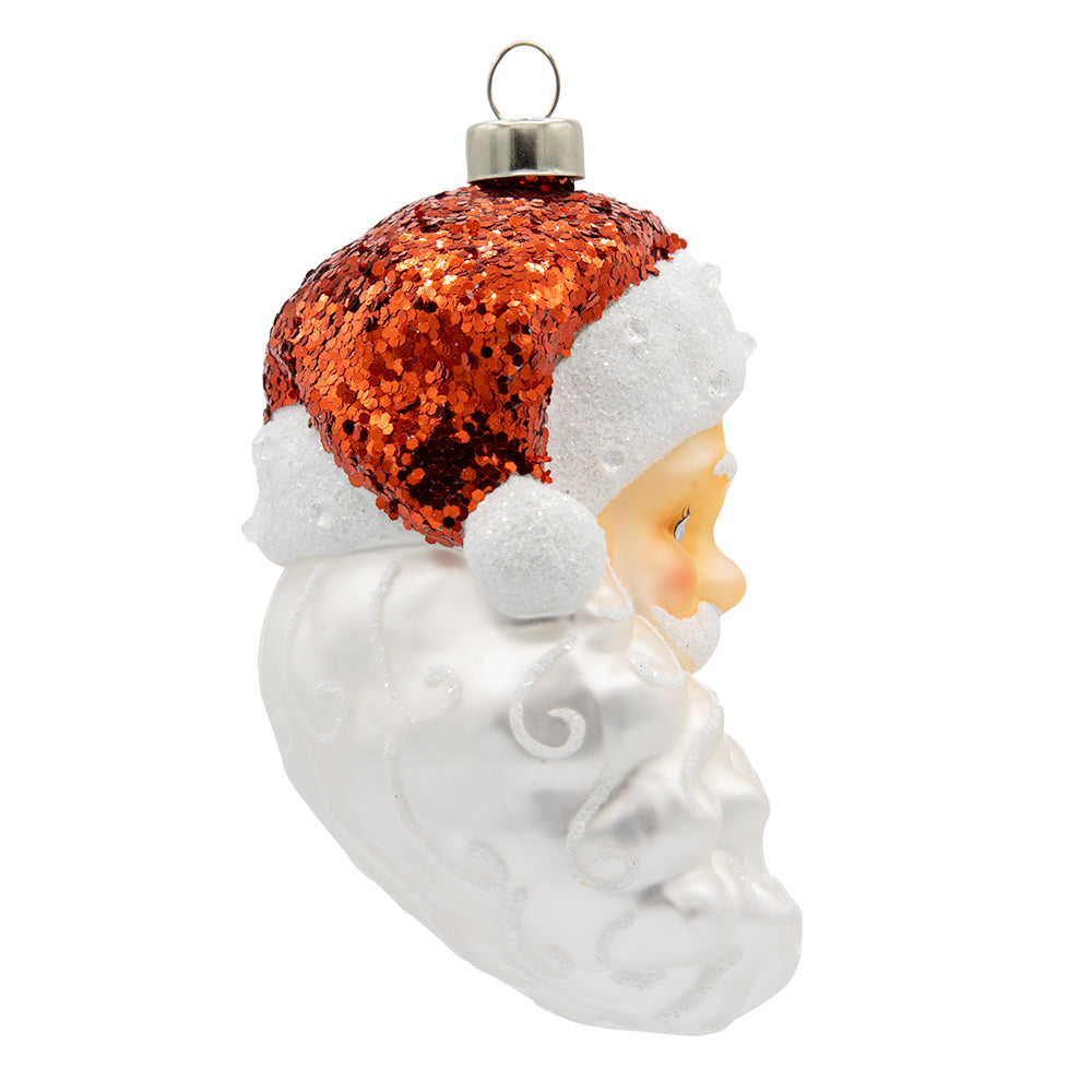 Traditional Santa ornament. Santa is seen wearing a red sequined hat with sparkling white details in his beard. View of left side.