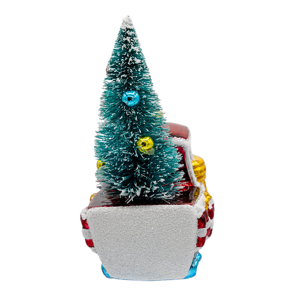 Merry Motorboat ornament. A decorated Christmas tree sits on the back of a sailboat. View of left side.
