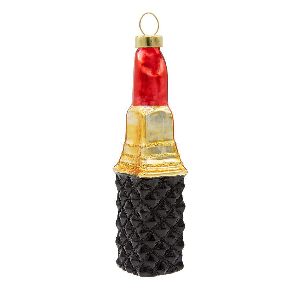 Festive Red Lipstick ornament. A stick of red lipstick with a black geometric patterned base. View of front.
