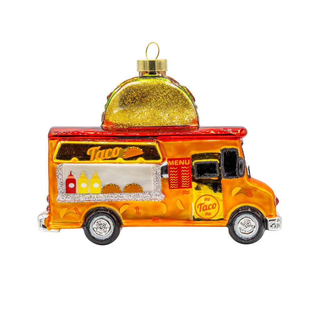 Taco Truck ornament. An orange and red taco truck with a glittery gold taco on top. View of front.