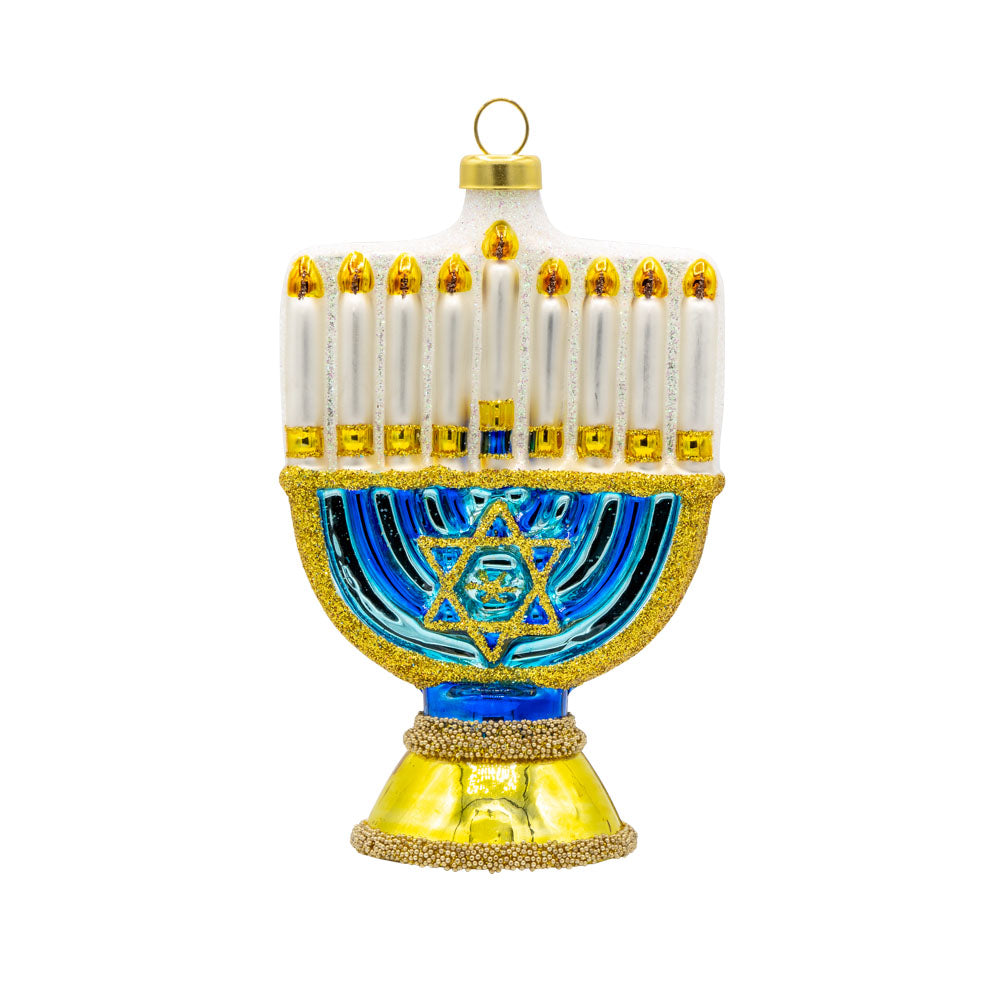 Menorah ornament. A gold and blue menorah with glittery details. View of front.