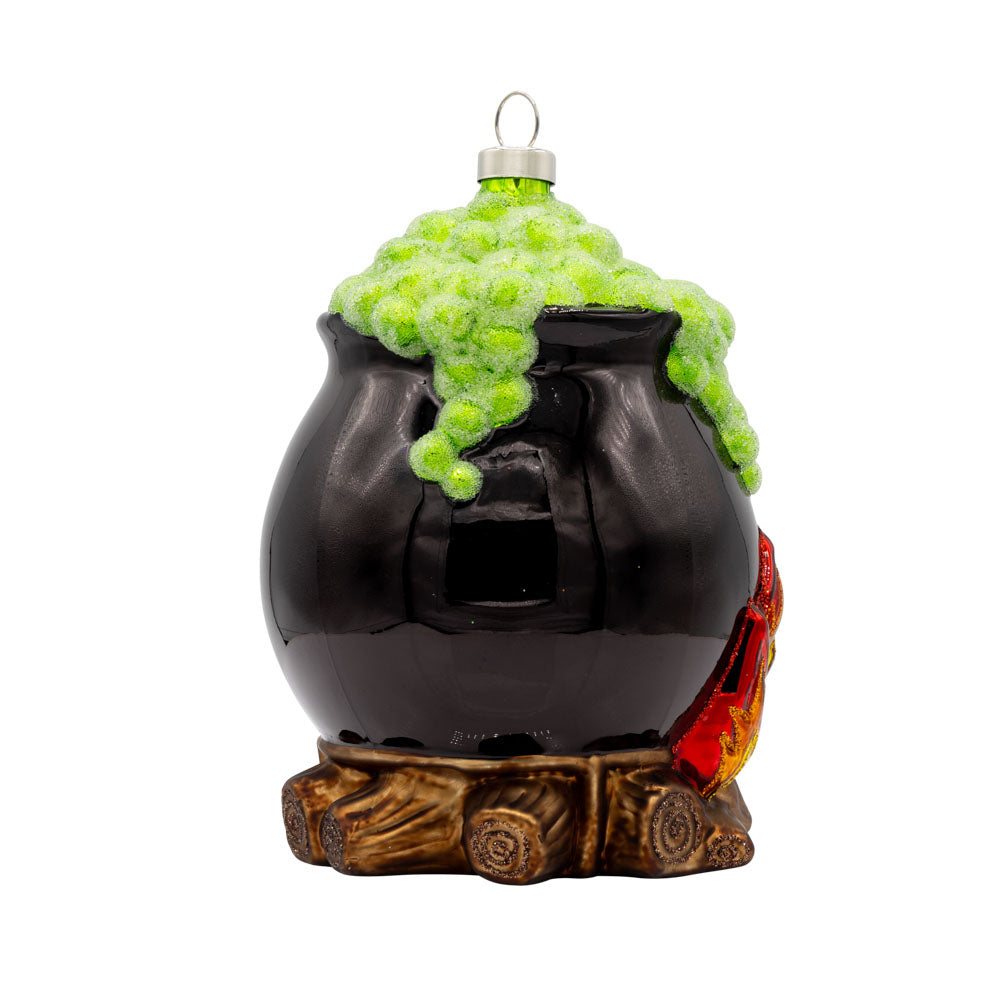 Spooky Cauldron ornament. A black cauldron over a fire with green foam coming out the top. View of left side.