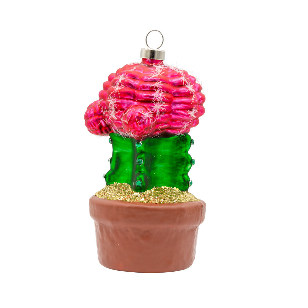 Desert Bloom Cactus ornament. A potted green cactus with a bright pink blossom growing out the top. View of front.