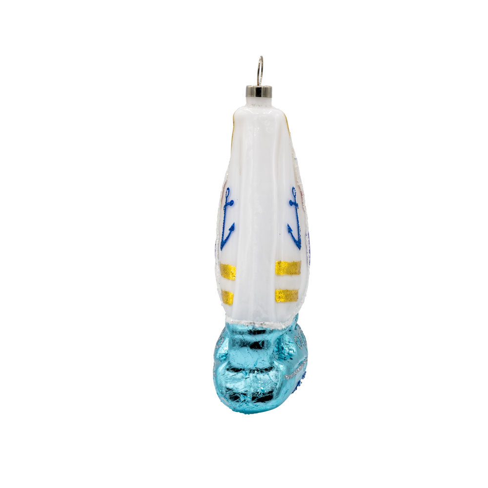 Sail Boat ornament. A sailboat cuts through the waves. View of left side.