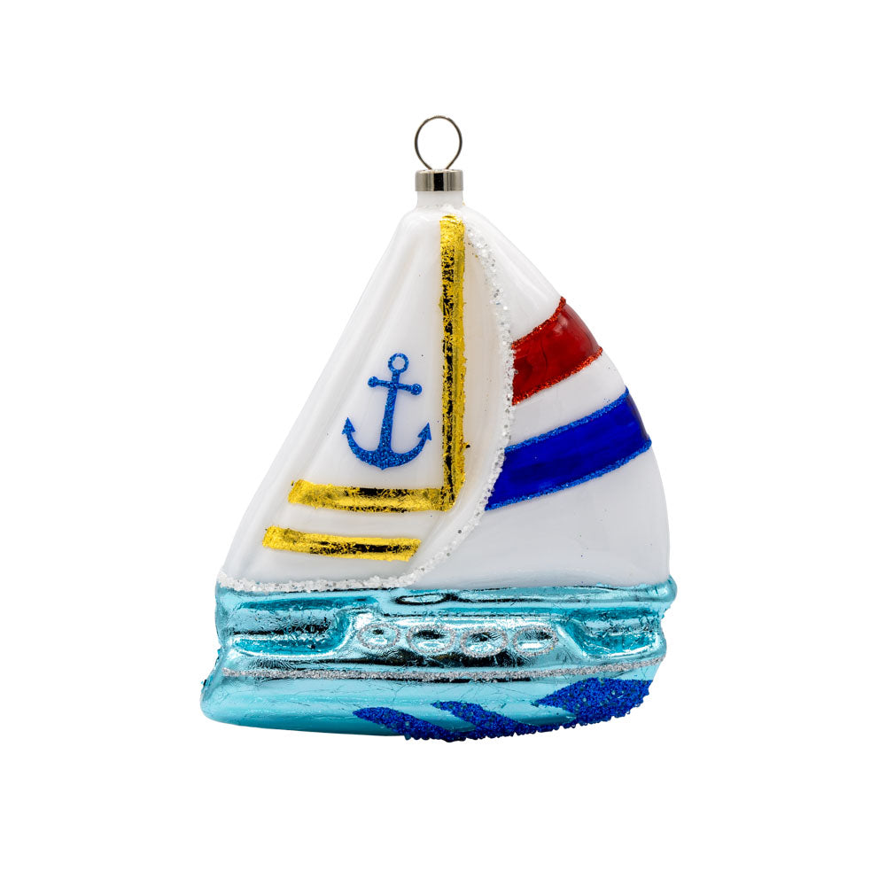Sail Boat ornament. A sailboat cuts through the waves. View of front.