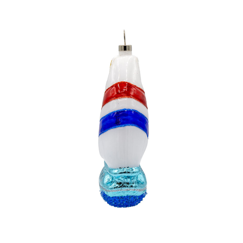 Sail Boat ornament. A sailboat cuts through the waves. View of right side.