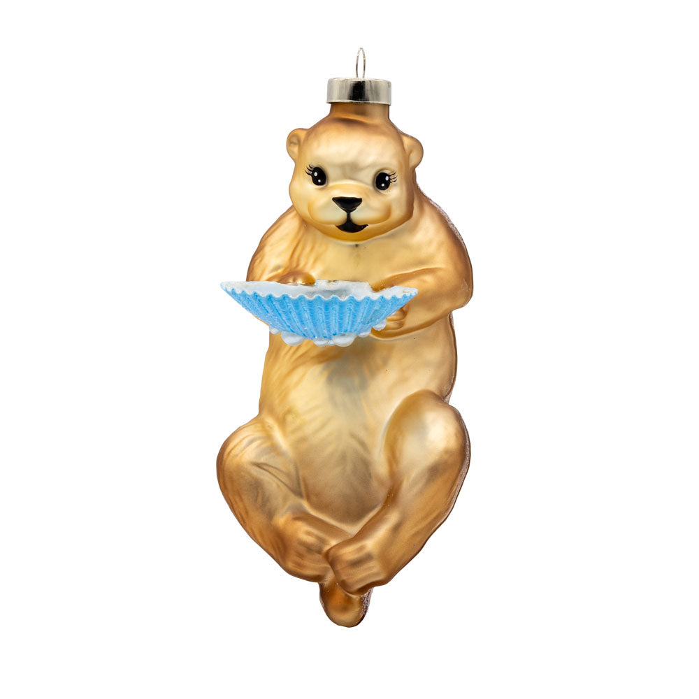 Sea Otter ornament. This otter holds a glittery blue shell. View of front.
