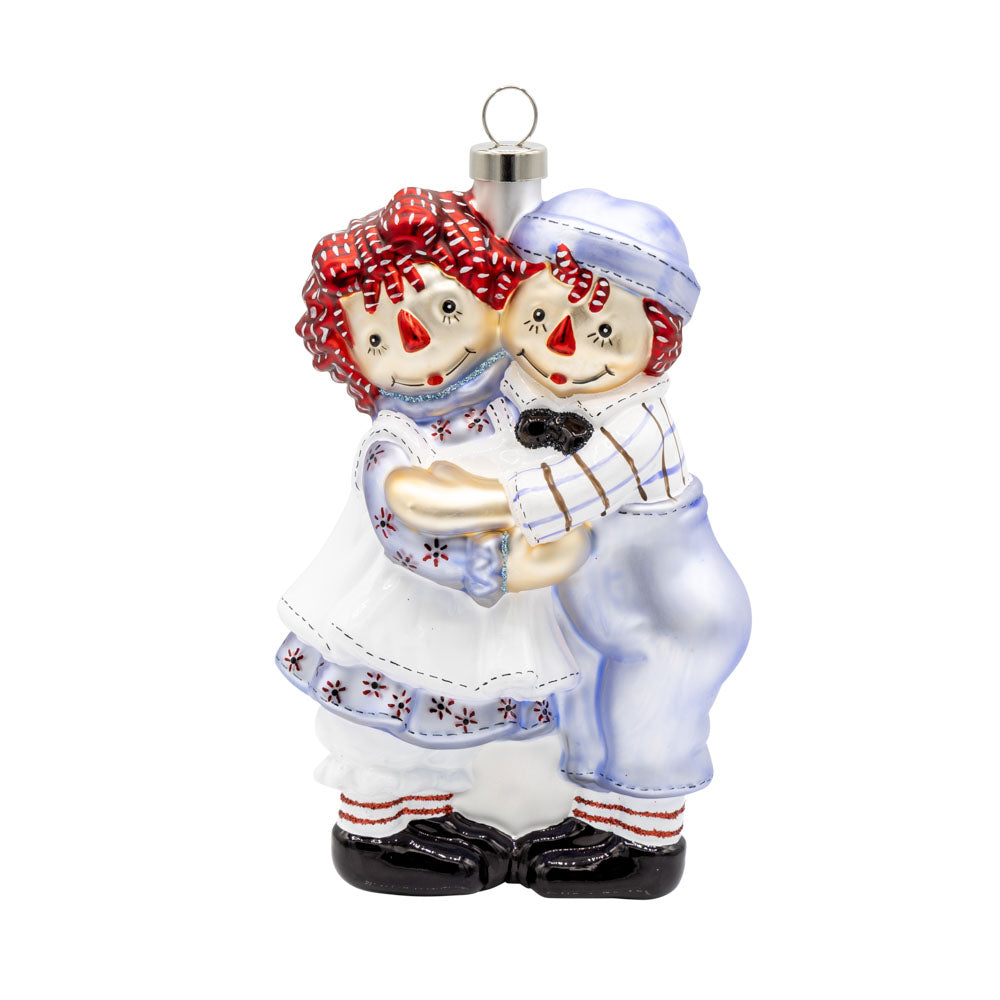 This heartwarming ornament features Raggedy Ann and Raggedy Andy hugging viewed from the front.
