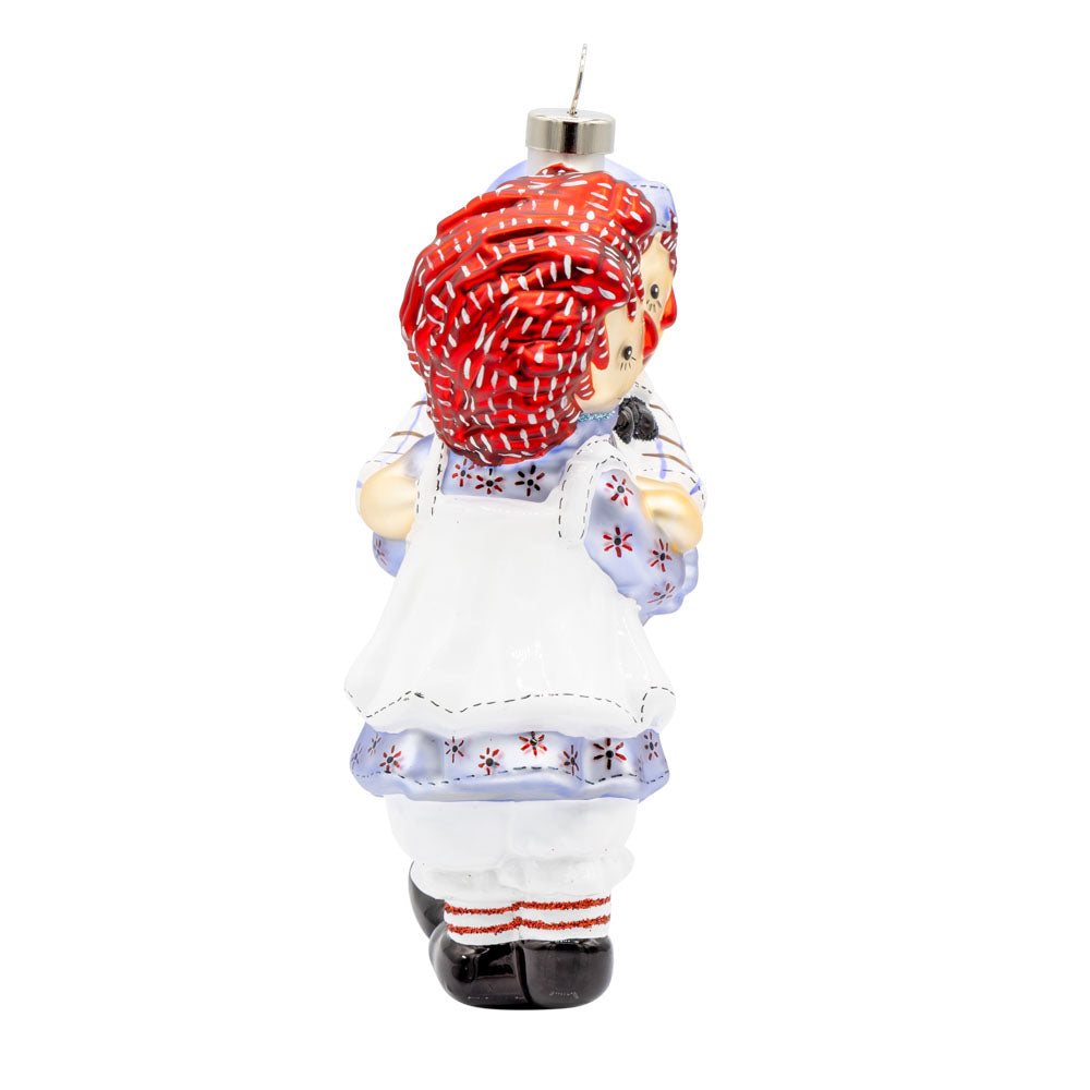 This heartwarming ornament features Raggedy Ann and Raggedy Andy hugging viewed from the left side.