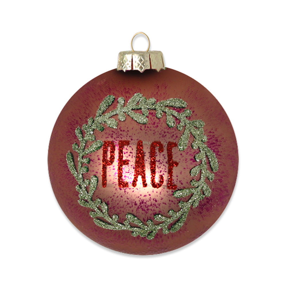 Rose Gold "Peace" ornament. Rose gold glass round is charmingly with gold glitter "Peace" wreath. View of front.