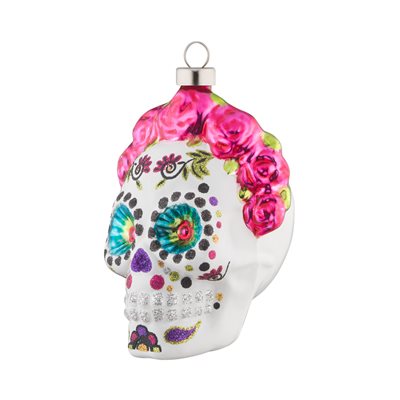 Dia de Los Muertos Rose Skull ornament. A decorated Dia de los Muertos white glass skull accented with a pink rose crown. View of front right.