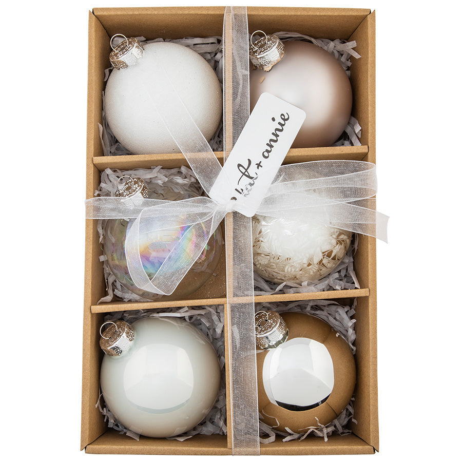 Shimmering in the crisp whites and silvers of a fresh winter's snowfall, this gorgeous set of 6 rounds is a classic neutral foundation for any ornament collection.