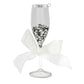 Wedding Champagne Toast ornament.  A champagne flute filled with silver sequins and a white ribbon tied around the stem. View of front. 