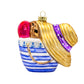 Beach Bag Essentials ornament. A blue striped beach bag holds red flip flops, a pair of shades, and a straw sun hat with a purple bow. View of back.