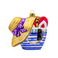 Beach Bag Essentials ornament. A blue striped beach bag holds red flip flops, a pair of shades, and a straw sun hat with a purple bow. View of front. 