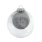 A radiant, silver glittered ornament is housed within a larger transparent glass round creating added depth for this stunning ornament.