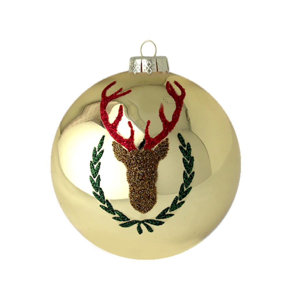 The resplendant gold shiny finish of the glass round is bedecked in red, gold, and green glitter that provides a silhouette of a regal reindeer.