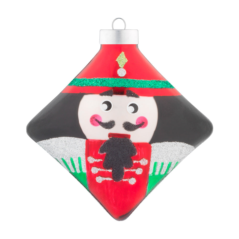 This cute nutcracker is detailed with green and silver glitter and adorned with a cute mustache and rosy cheeks.