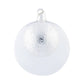 A radiant, dimpled ornament is housed within a larger transparent glass round creating added depth for this stunning ornament.