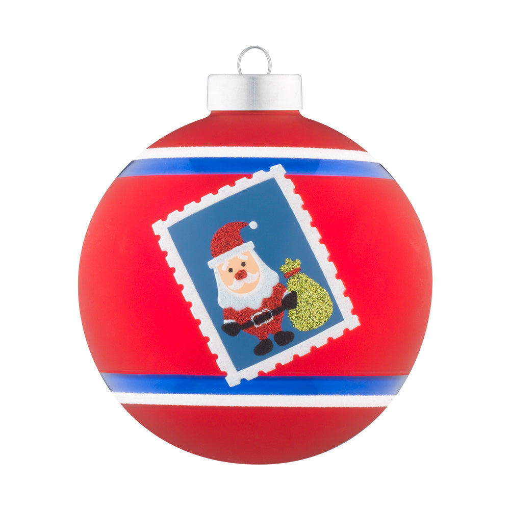 This red glass round is stamped with Santa and his tree.