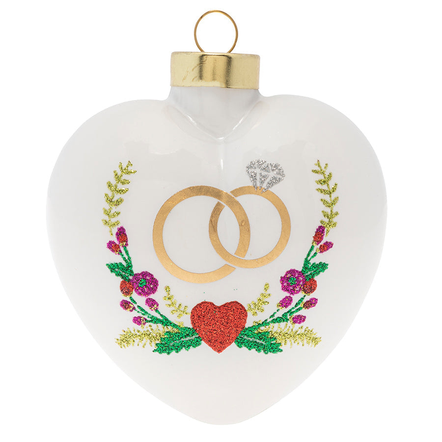 Happy Ever After! This lovely heart shaped ornament highlights wedding rings with a garland of lovely florals surrounding them.
