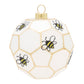 Our white honeycomb-shaped round is buzzing with bees whirling all around it.