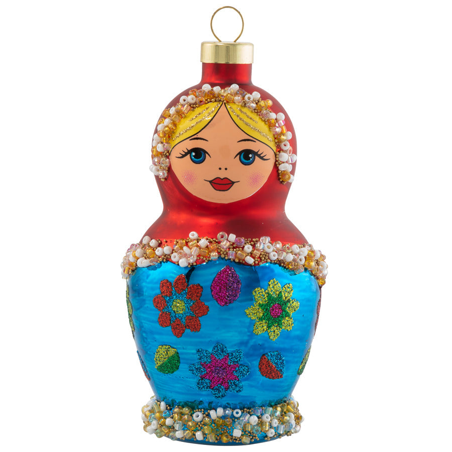 This nesting folk doll features sweet eyes, rosy cheeks, beaded trim details, and many layers to her personality!