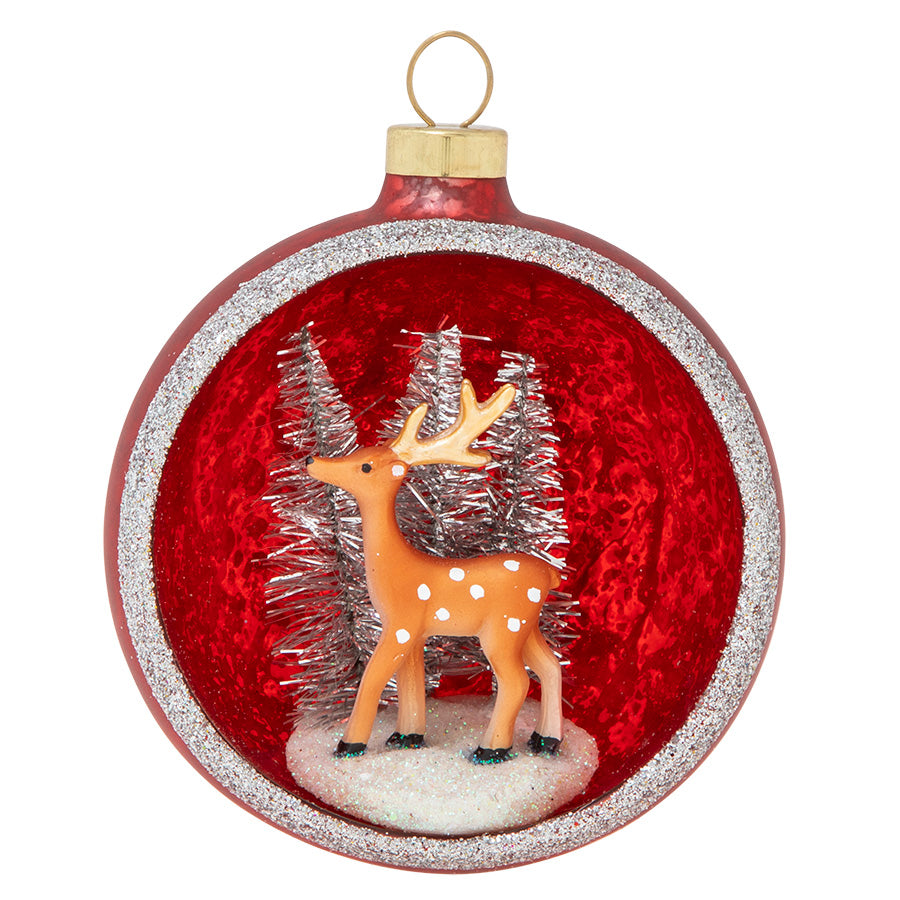 Among silvery winter trees against a backdrop of ruby red, a noble reindeer is the star of this shimmering snowscape.