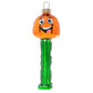 A goofy jack-o-lantern grins from his perch atop a bright green PEZ dispenser in this officially licensed PEZ ornament.   