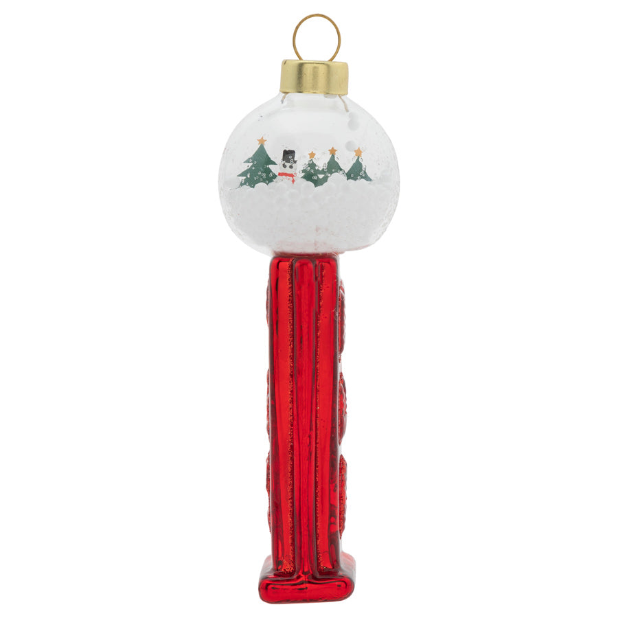 Let it snow! A frosty winter scene shines from inside a tiny snow globe atop this cheery red PEZ™ dispenser ornament.