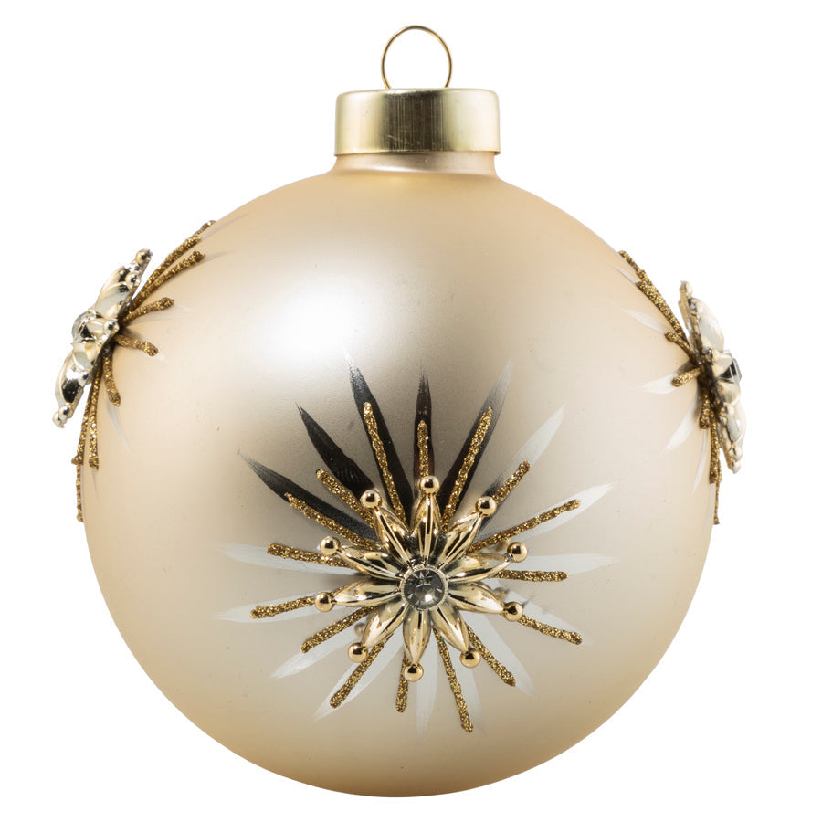 A satin champagne orb is the perfect place for an applique gold and crystal snowflake to sit atop a hand painted silver and gold glitter star burst.