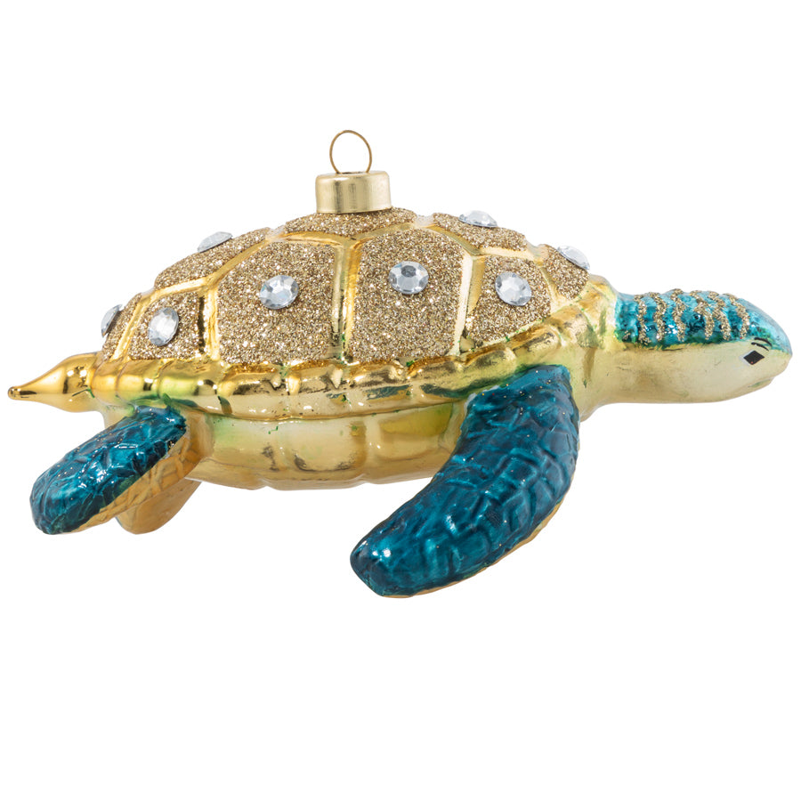 The true beauty of the sea turtle shines with turquoise flippers protected by a gilded and glittered crystal studded shell.