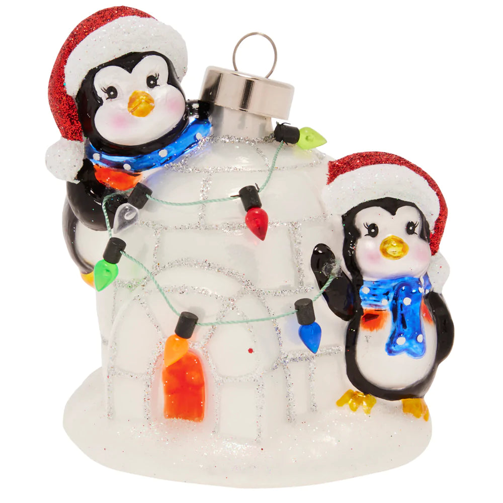 These playful penguins are ready for winter, staying sheltered from the snow in their trusty igloo!